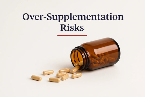 Editorial 3:2 horizontal image showing an amber supplement bottle tipped over with capsules spilling onto a clean white surface, with the title ‘Over-Supplementation Risks.