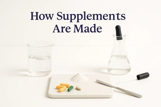 Clinical lab-style editorial image featuring glass beakers, droppers, white powders, and capsules arranged on a clean white background with the title ‘How Supplements Are Made.